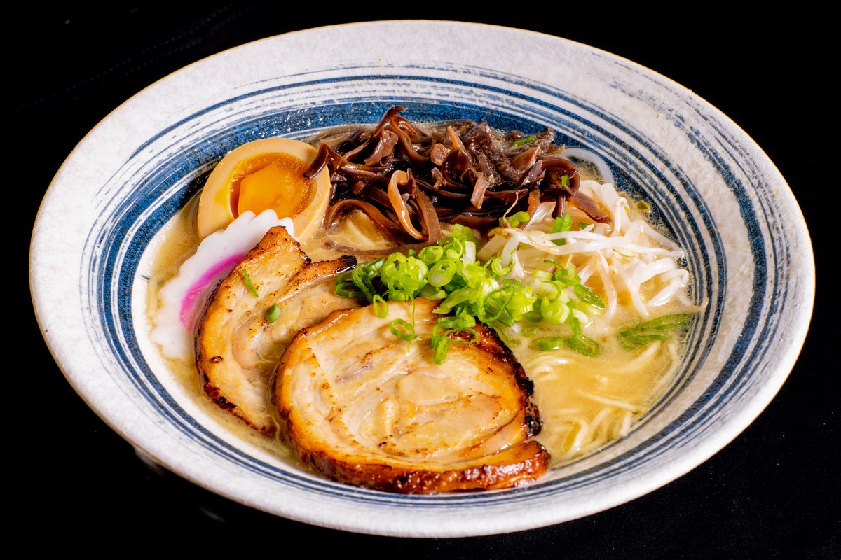 Ramen with pork chashu, black fungus and scallions in a blue-rimmed bowl at Hungry Station McDonough