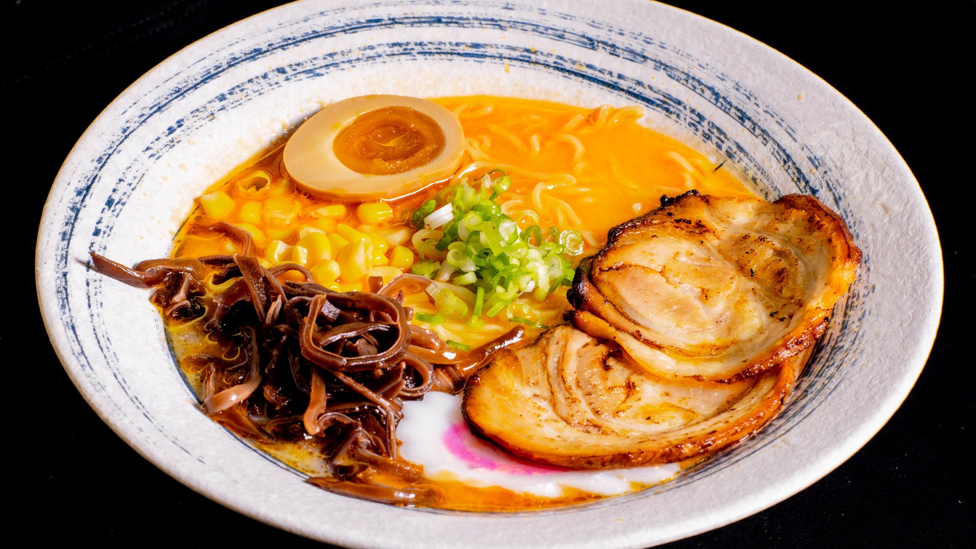 Spicy ramen with pork chashu, black fungus and sweet corn