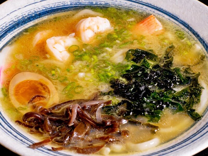 Seafood udon ramen with shrimp, seaweed and a soft-boiled egg